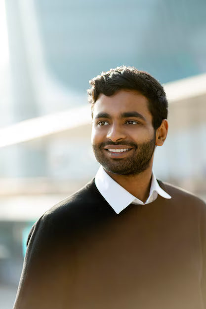 files/portrait-smiling-handsome-indian-man-looking-away-street_695242-1224.avif